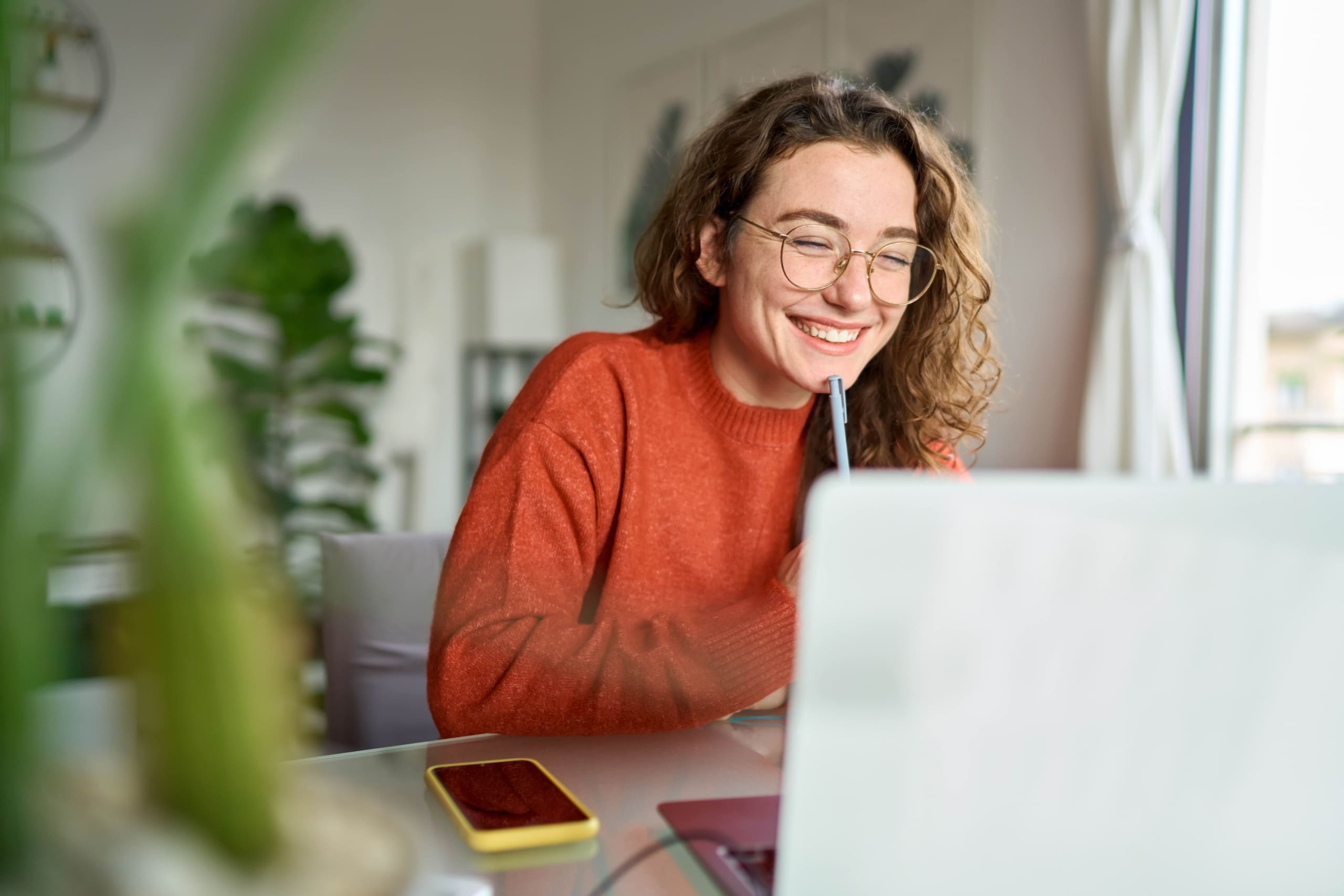 Woman using a no code learning management system to write notes